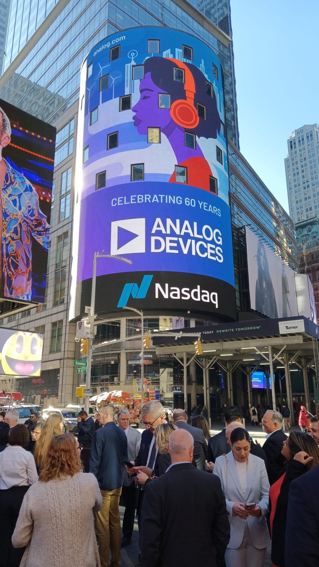 the 60th anniversary animation lighting up the NASDAQ screen in Times Square.